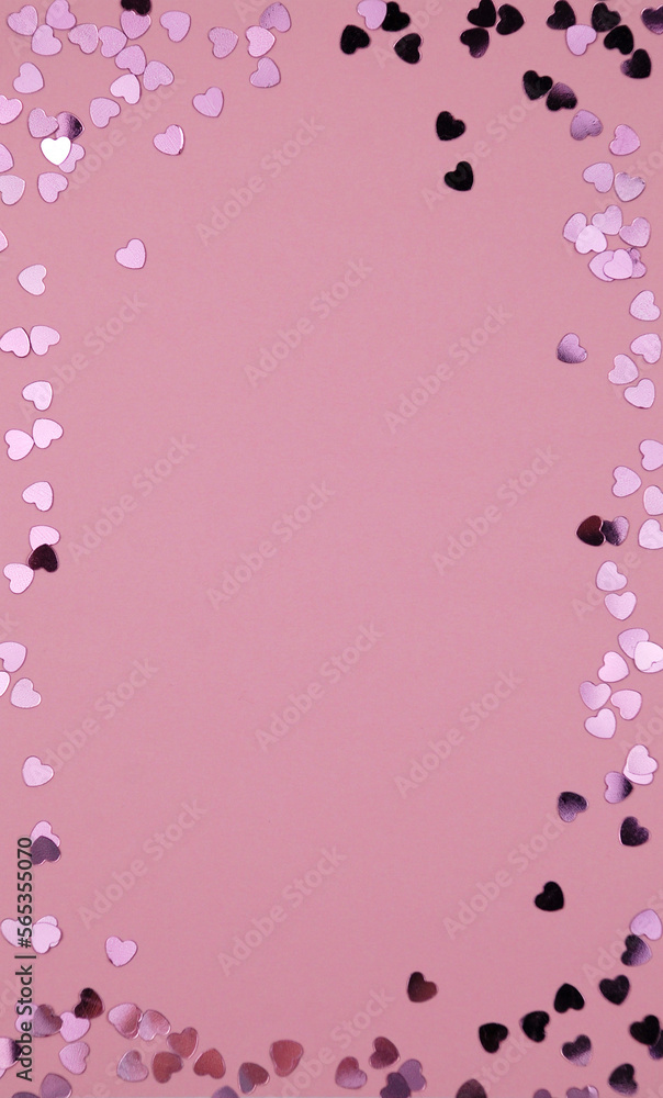 heart shaped confetti on pink paper
