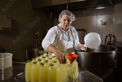 young woman preparation of cottage cheese on local farm 