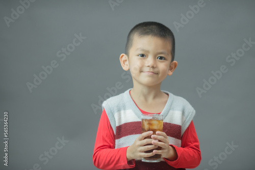 Cute little boy drinking water from glass,Little asian boy drinking soft drink photo