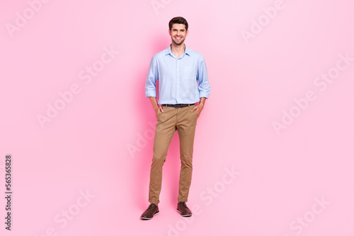 Full length photo of good nice looking man dressed fashionable clothes stand arm pocket isolated on pink color background © deagreez