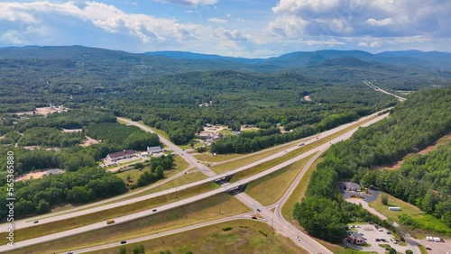 Interstate Highway I-93 at Exit 28 in summer with White Mountain National Forest at the background in town of Campton, New Hampshire NH, USA.  photo