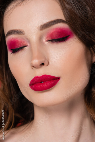 close up of young woman with magenta color makeup and closed eyes.