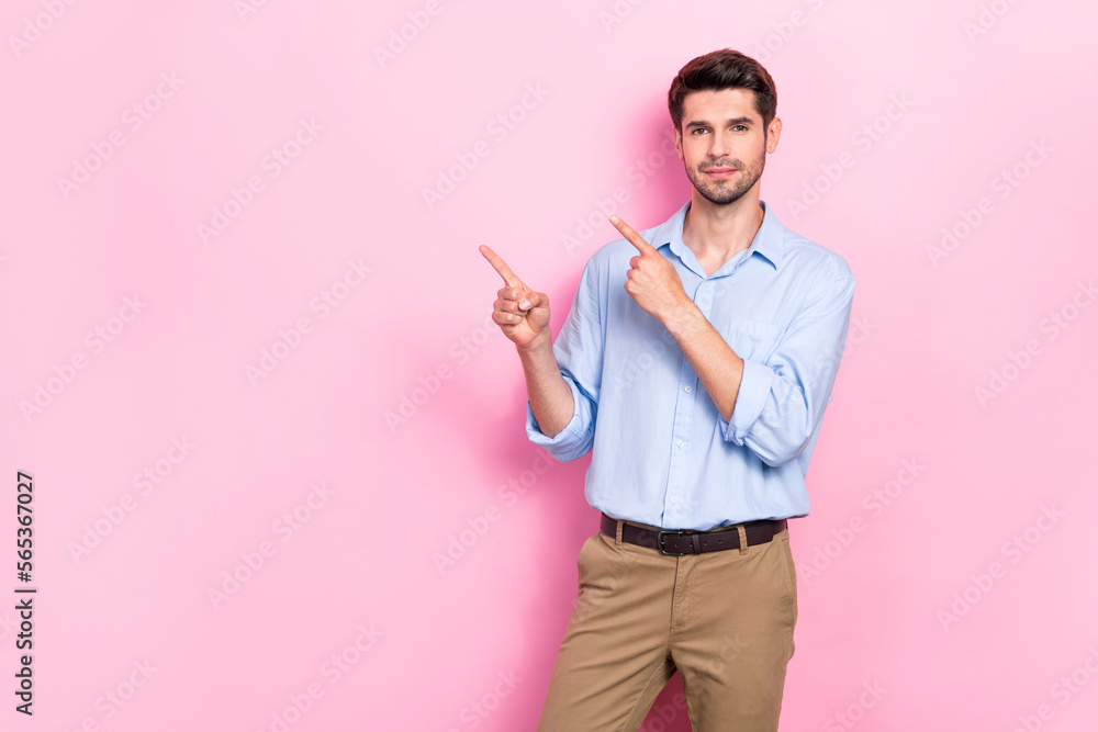 Photo of good looking serious man two arm direct empty space recommend visit new shop isolated on pink color background Photo of good looking serious man two arm direct empty space recommend visit new shop isolated on pink color background