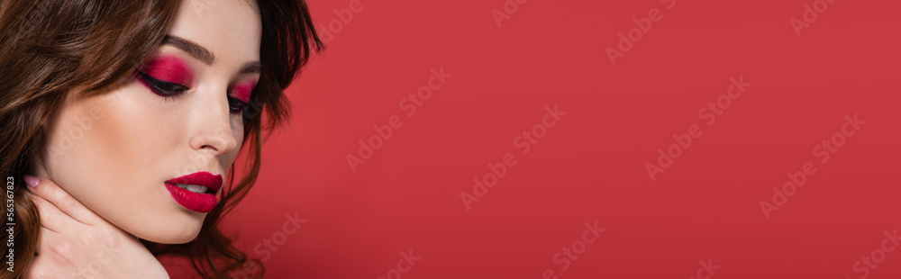 young woman with magenta color makeup touching neck isolated on pink, banner. young woman with magenta color makeup touching neck isolated on pink, banner.