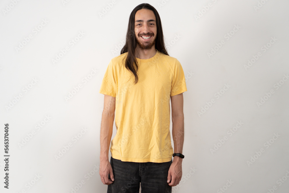 American shot of a smiling young latin slim bodied male model with long hair on a white background. American shot of a smiling young latin slim bodied male model with long hair on a white background.