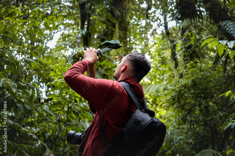 Unrecognizable traveler taking photo of forest Unrecognizable traveler taking photo of forest