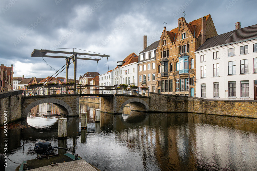A view of Bruges, a canal with a lift bridge and historical houses