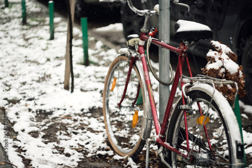 Parked bicycle in snow on the winter street of Novi Sad Serbia