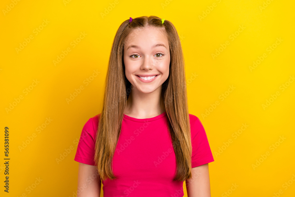 Portrait of satisfied pleasant cute adorable girl with long hairdo dressed pink top toothy smiling isolated on yellow color background Portrait of satisfied pleasant cute adorable girl with long hairdo dressed pink top toothy smiling isolated on yellow color background