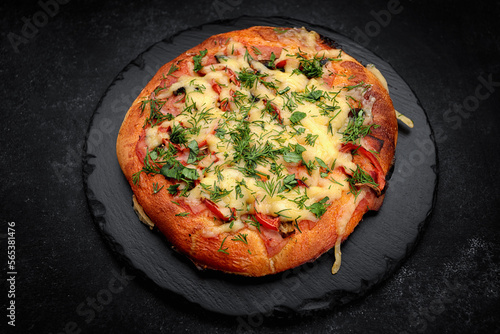 Baked pizza with tomatoes, cheese and sausage, street food