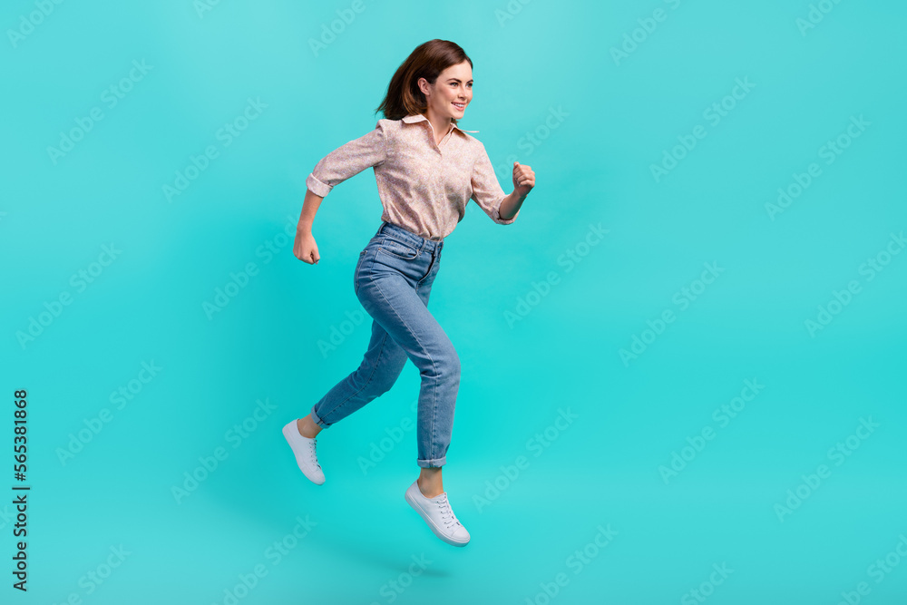 Full length photo of funky excited girl dressed pink shirt jumping high hurrying isolated teal color background