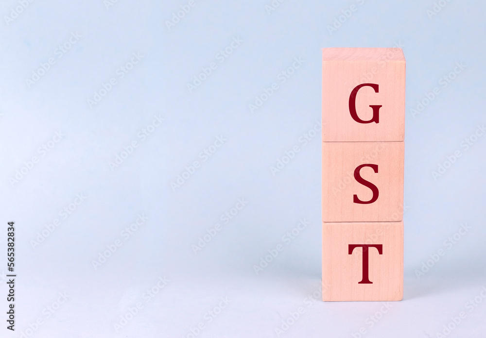GST on wooden cubes on a blue background GST on wooden cubes on a blue background