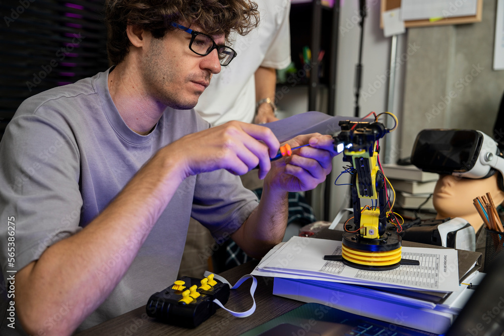 Modern male engineer and expert in programming and manipulation of ...