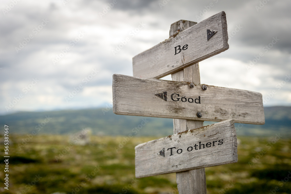 be good to others text quote on wooden signpost outdoors in nature