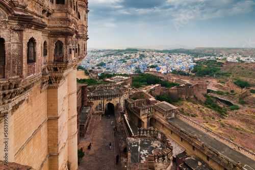 Top view of Mehrangarh fort with distant view of blue city Jodhpur, Rajasthan, India. Blue sky with white clouds in the background. Historical Fort is UNESCO world heritage site