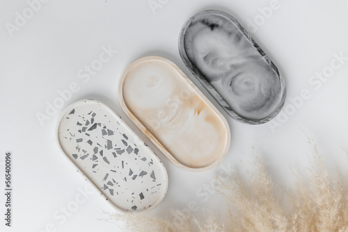 Handmade round concrete coasters with abstract creative terrazzo pattern. Granite shards. Colorful texture of stones and rocks. Neutral concrete terrazzo coasters. Recycled materials. Home Decor.