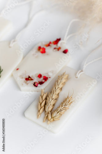 Aroma sachet with dried flowers with coconut or organic soy wax. Close up on white background