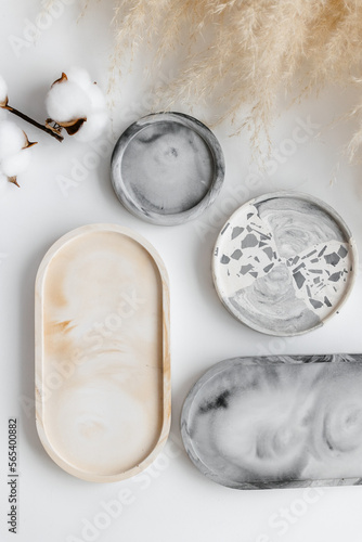 Hand cast round concrete coasters with terrazzo abstract creative pattern. Granite fragments. Stones and rocks color texture. Neutral Terrazzo Concrete Coasters. Recycled materials. Decor for home