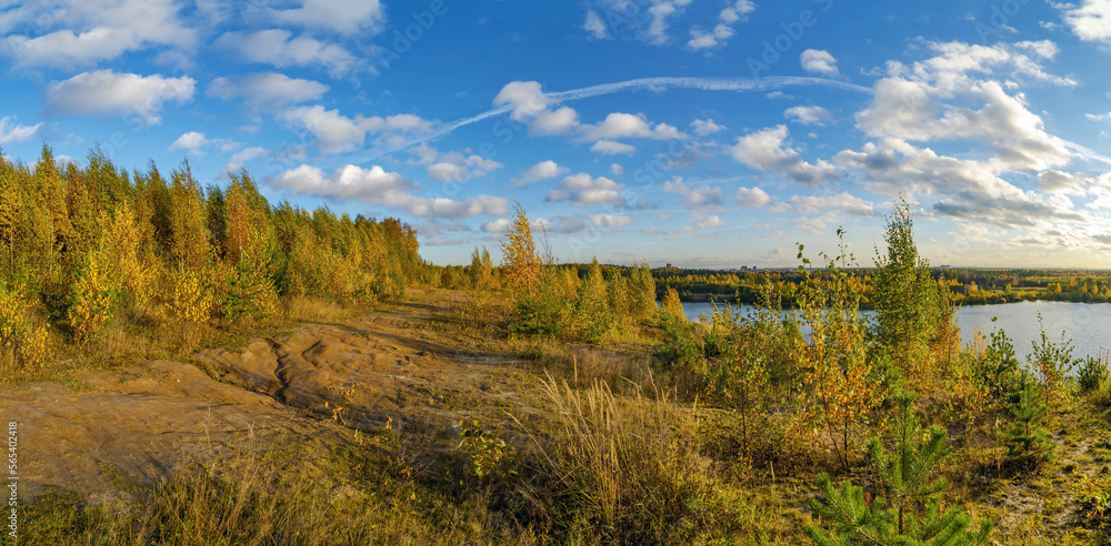Picturesque lake shore in autumn on a bright sunny day .