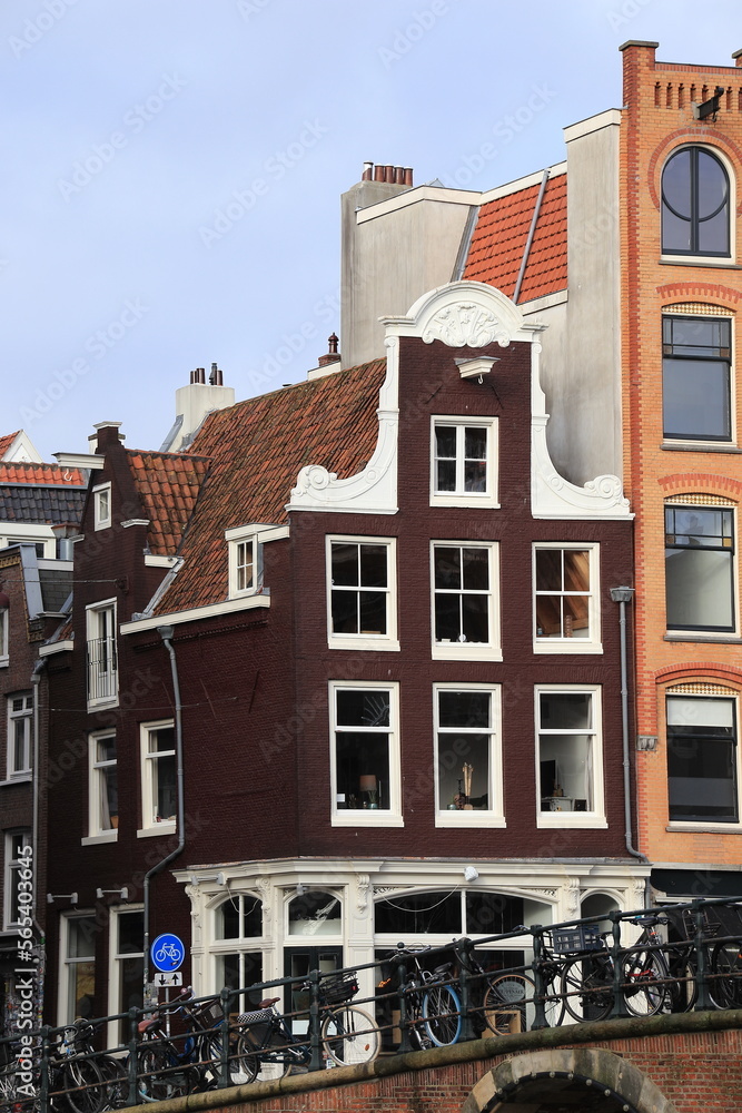 Fototapeta premium Amsterdam Singel Canal House Facade with Bridge and Bicycles, Netherlands