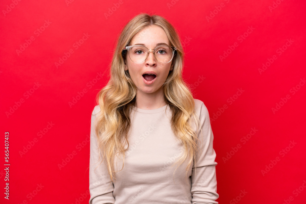 Young English woman isolated on red background With glasses and surprised expression Young English woman isolated on red background With glasses and surprised expression