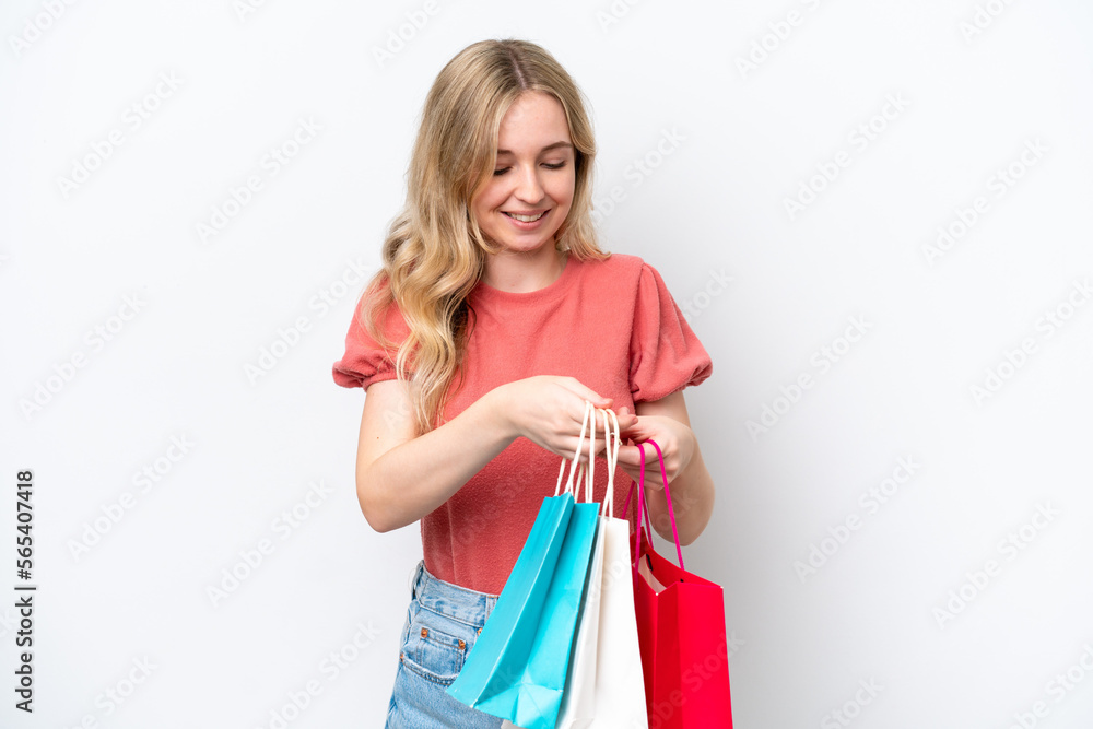 Young English woman isolated on white background holding shopping bags and looking inside it