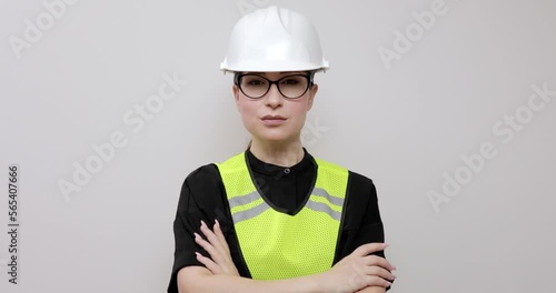 Portrait of a female engineer in a protective vest and hard hat with goggles.Industry, engineer and construction concept.