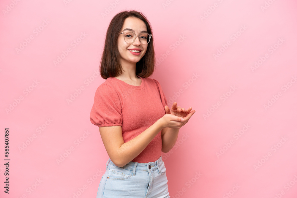 Young Ukrainian woman isolated on pink background applauding Young Ukrainian woman isolated on pink background applauding