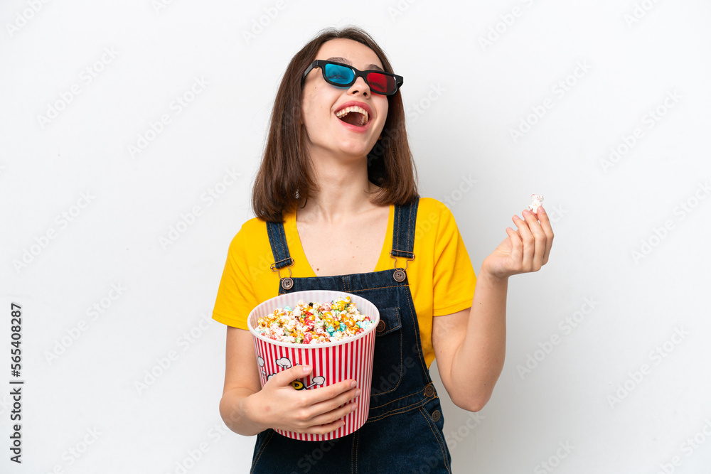 Young Ukrainian woman isolated on white background with 3d glasses and holding a big bucket of popcorns Young Ukrainian woman isolated on white background with 3d glasses and holding a big bucket of popcorns