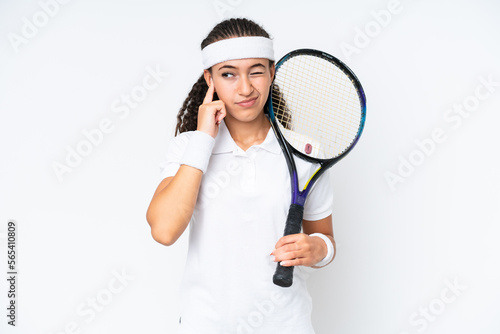Young tennis player woman isolated on white background frustrated and covering ears © luismolinero