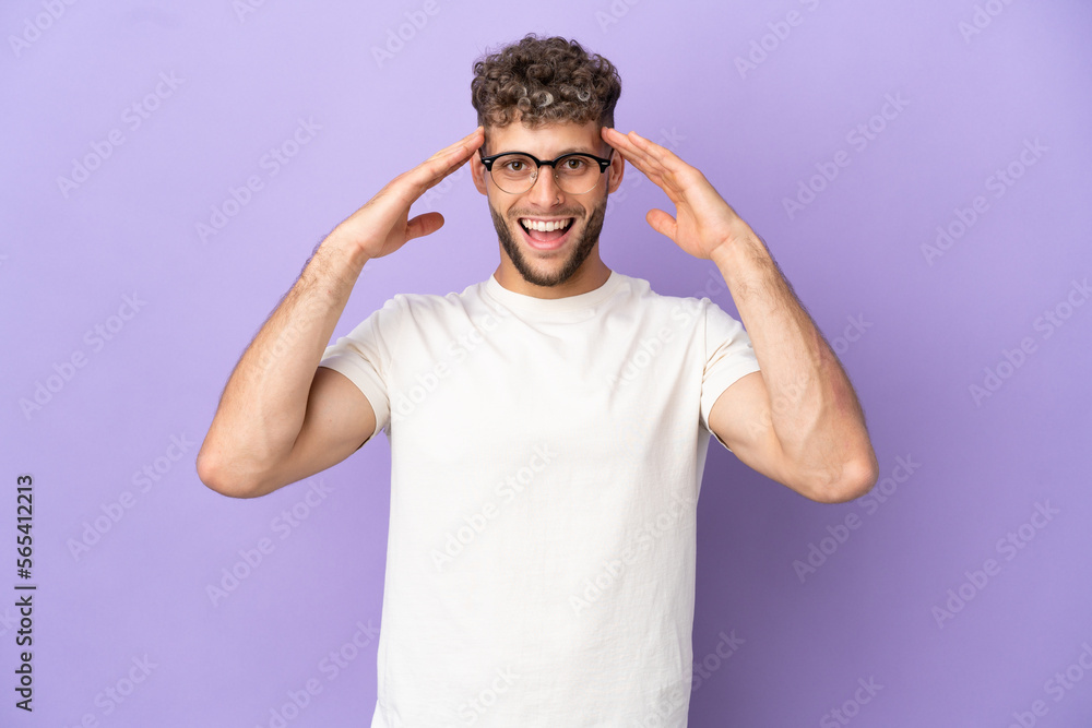 Delivery caucasian man isolated on purple background with surprise expression Delivery caucasian man isolated on purple background with surprise expression