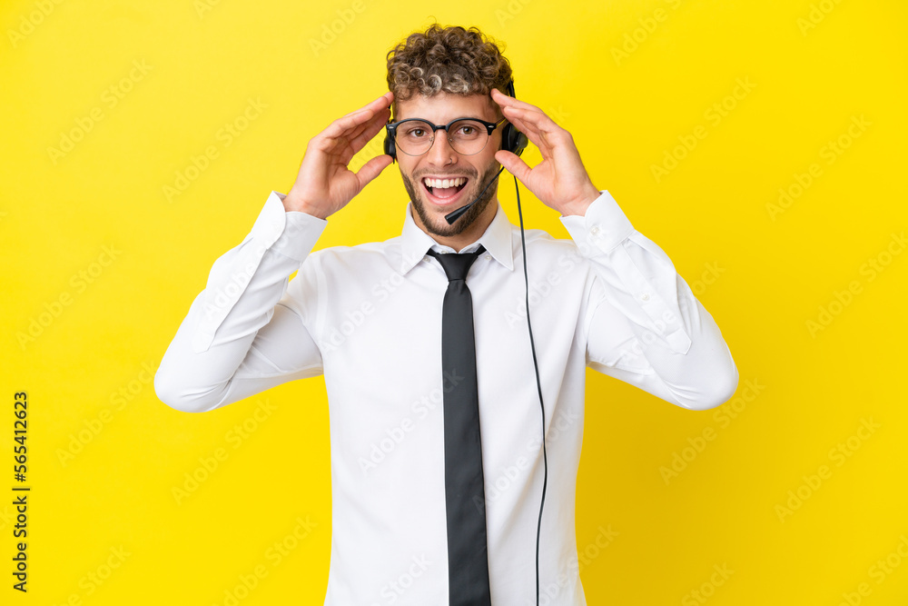 Telemarketer blonde man working with a headset isolated on yellow background with surprise expression Telemarketer blonde man working with a headset isolated on yellow background with surprise expression