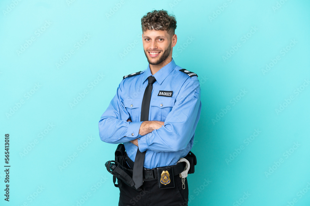Young police blonde man isolated white on blue background with arms crossed and looking forward Young police blonde man isolated white on blue background with arms crossed and looking forward