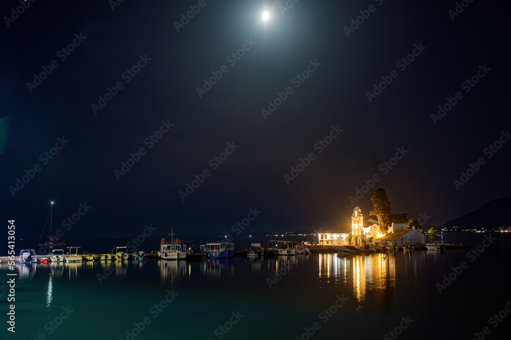 KANONI, CORFU, GREECE - September 19, 2021:Illuminated night scene of Vlacherna monastery and Pontikonisi island, Kanoni, Corfu
