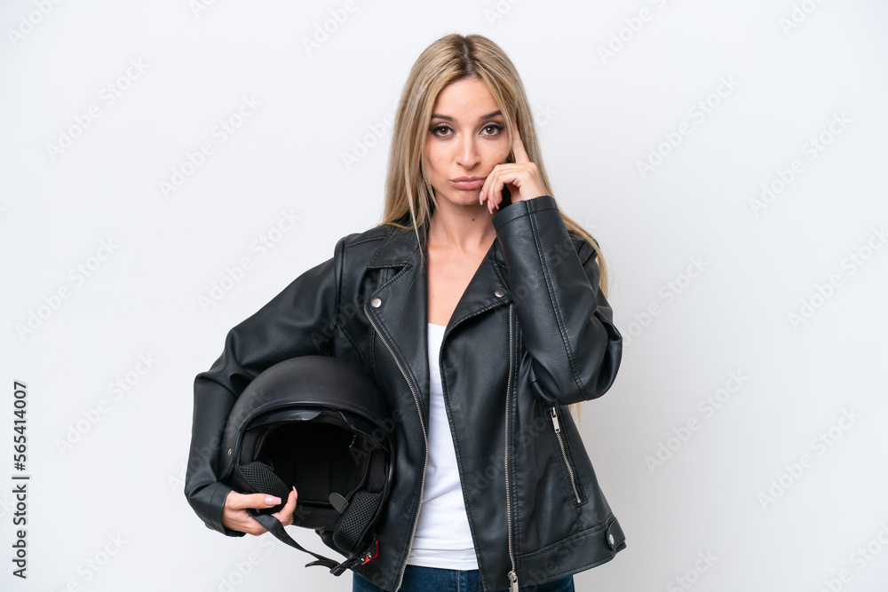 Pretty blonde woman with a motorcycle helmet isolated on white background thinking an idea Pretty blonde woman with a motorcycle helmet isolated on white background thinking an idea