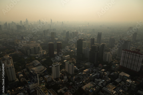 Panoramic view of the skyline of Bangkok  Thailand  at sunset  with its skyscrapers  plunged in pollution  from the observation deck of the Baiyoke Tower II