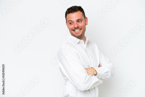 Young caucasian handsome man isolated on white background looking to the side and smiling © luismolinero