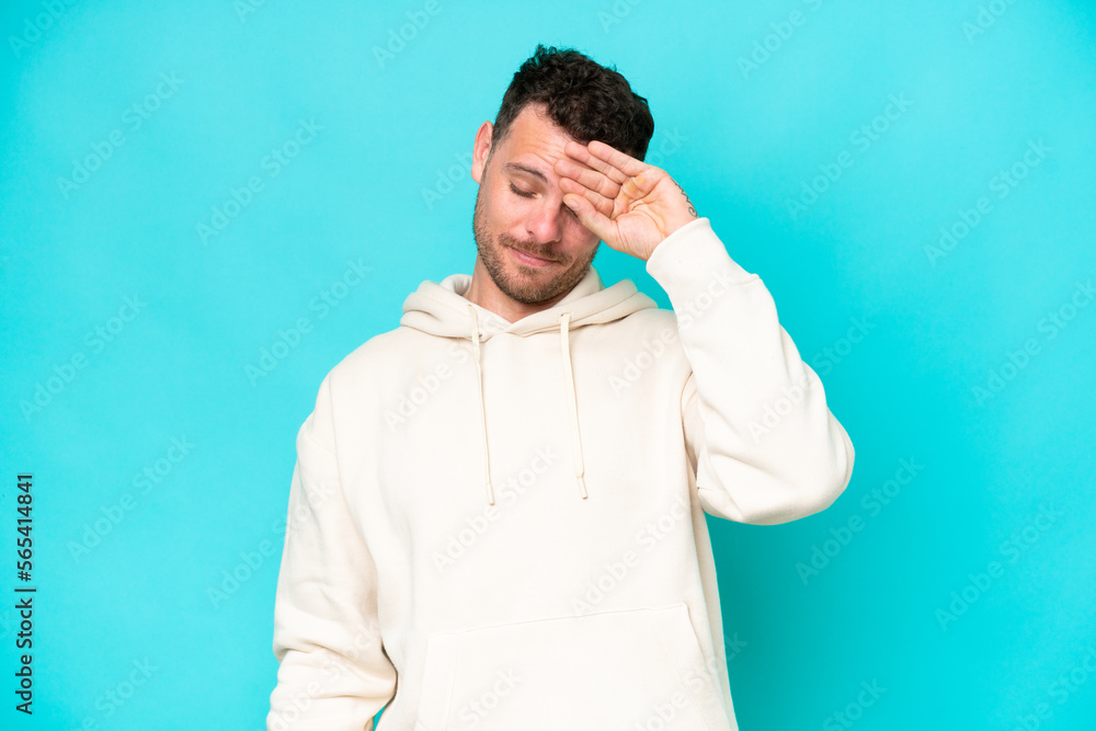 Young caucasian handsome man isolated on blue background with tired and sick expression Young caucasian handsome man isolated on blue background with tired and sick expression