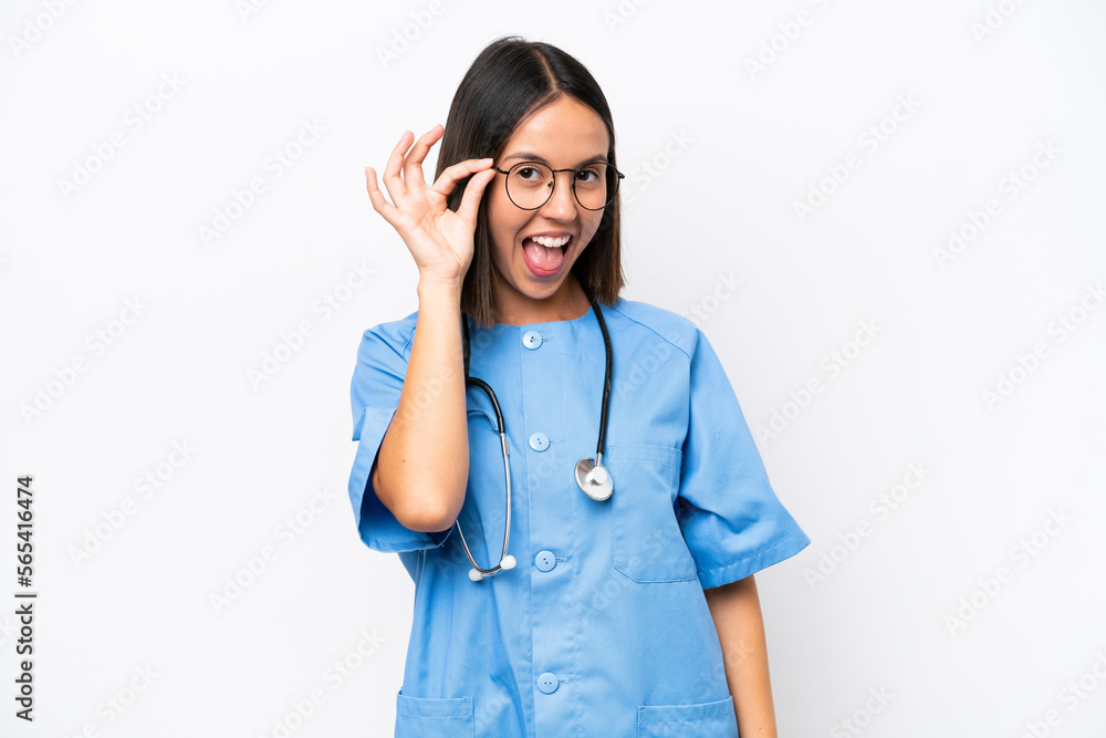 Young surgeon doctor woman isolated on white background with glasses and surprised Young surgeon doctor woman isolated on white background with glasses and surprised