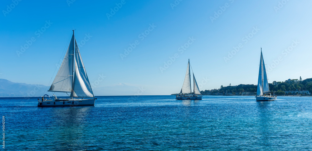 Obraz premium sailing yacht boats with white sails in blue sea , seascape of beautiful ships in sea gulf with mountain coast on background