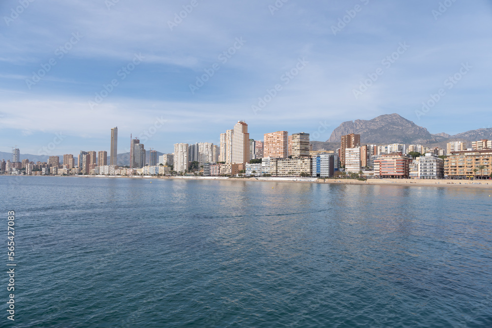 Landscape of the city of Benidorm in front of the Mediterranean coast. City with skyscrapers on the beachfront. View of the city of Benidorm from the sea. 