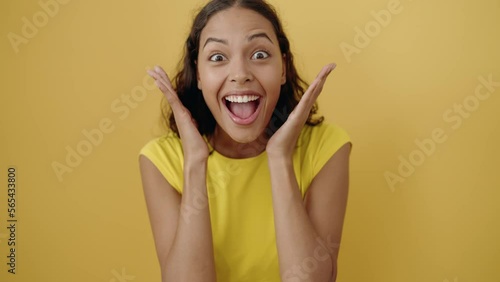 Young african american woman standing with surprise expression over isolated yellow background