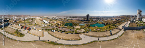 Urban panorama of the city of Angelopolis, Puebla surrounded by residential streets and green areas on a sunny day.