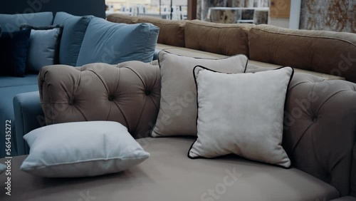 A brown sofa with beige cushions filmed in slow motion. 4k video