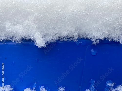 snow lies on a blue object