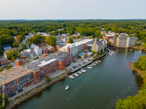 Newmarket Mills building aerial view on Lamprey River on Main Street in historic town center of Newmarket, New Hampshire NH, USA. Now this building is Rivermoor Landing Apartment. photo