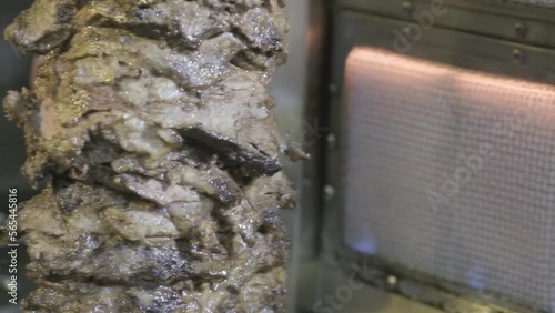 Carne asandose mientras rota en un horno electrico en camara lenta photo