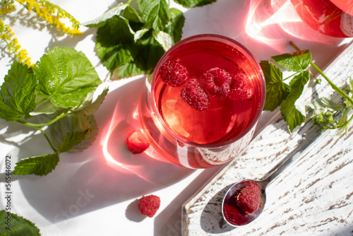 Drink with raspberries on a light background