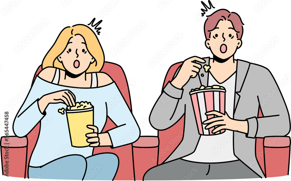 Couple eat popcorn sitting in cinema Couple eat popcorn sitting in cinema