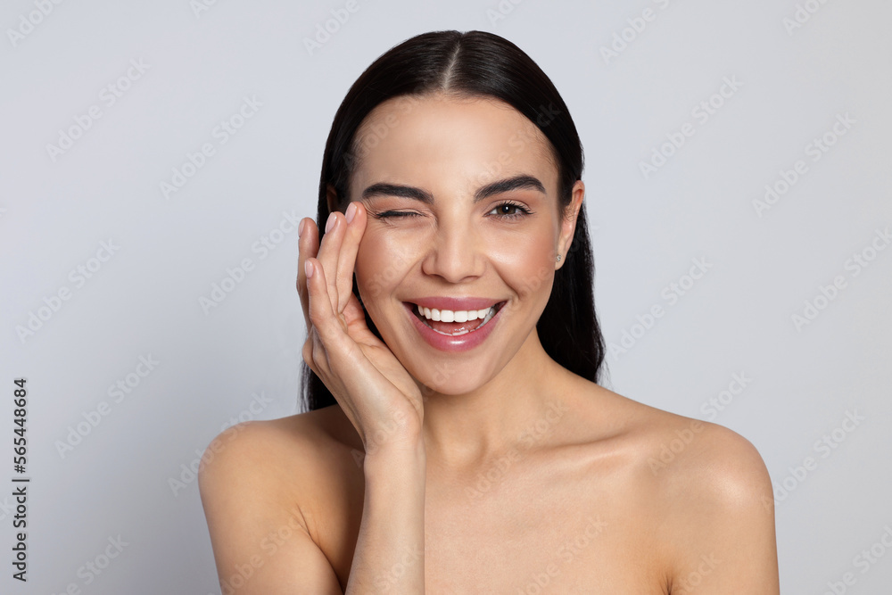 Portrait of attractive young woman on light grey background. Spa treatment Portrait of attractive young woman on light grey background. Spa treatment
